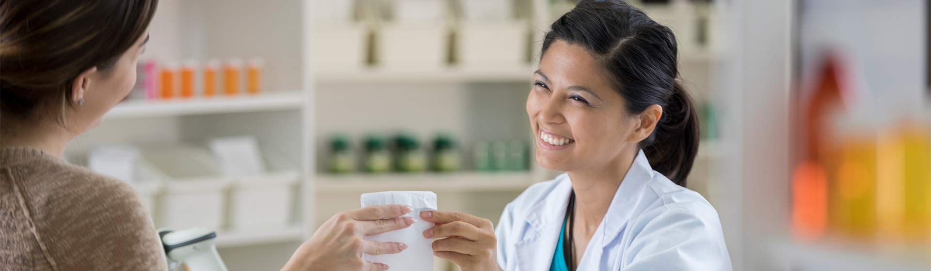 Pharmacist gives a customer their prescription