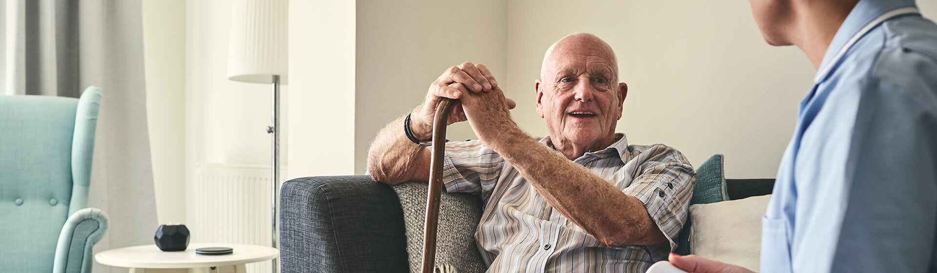 Elderly man speaking to nurse