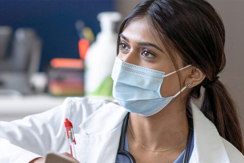 Woman doctor holding a pen