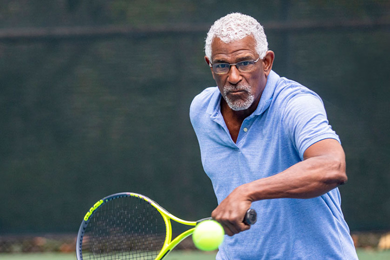 Middle-Aged Man Playing Tennis