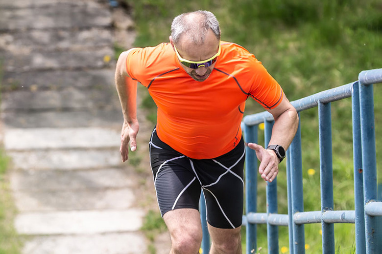 White Middle Aged Man Running Up Steps
